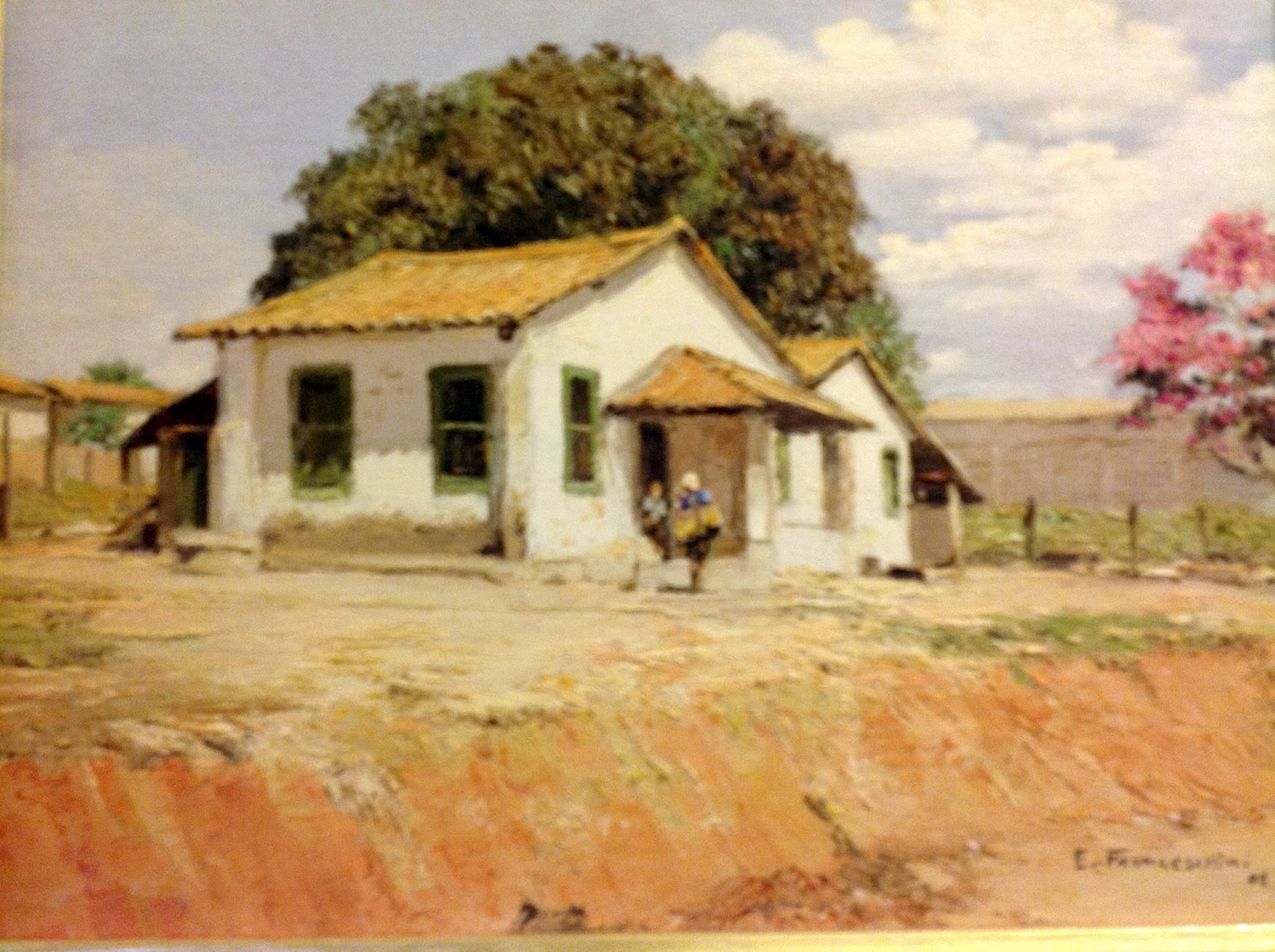 Casario — Pequenas casas junto a uma árvore de flores coloridas.