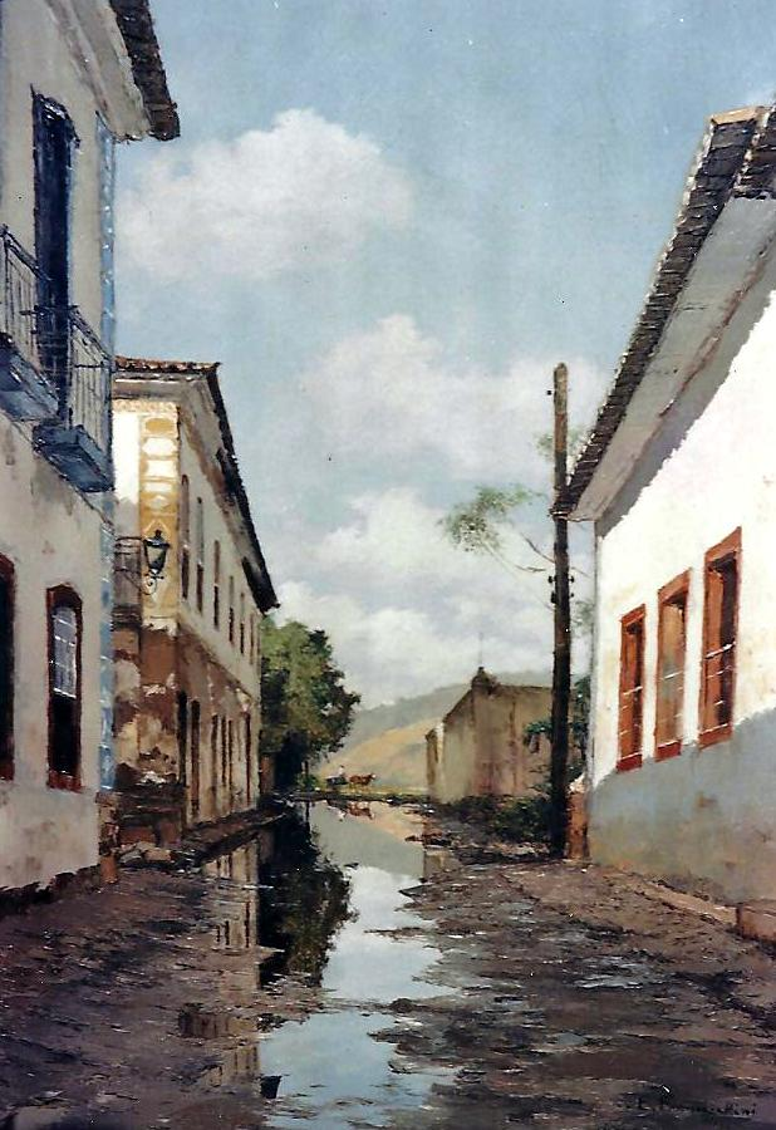 Reflexo — Casario e céu se refletem na água acumulada sobre a rua.